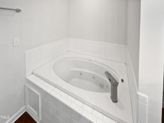 bathroom featuring a relaxing tiled tub