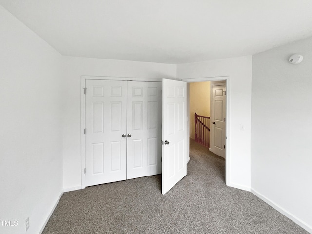 unfurnished bedroom with a closet and carpet