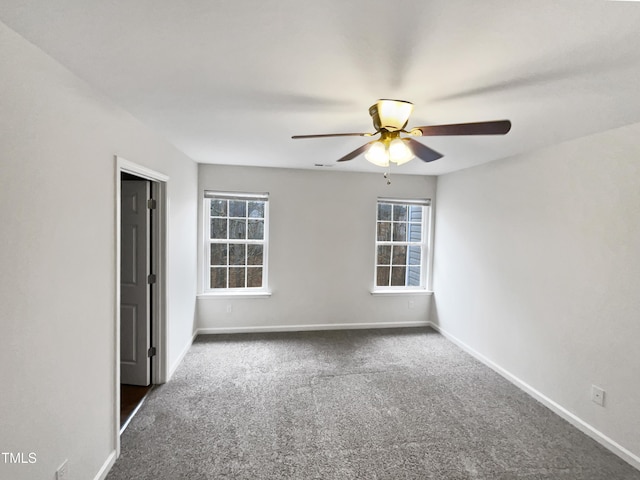 empty room featuring dark colored carpet and ceiling fan