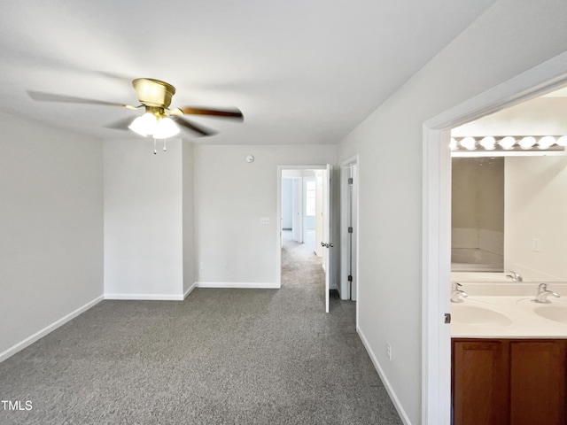 carpeted empty room with ceiling fan and sink