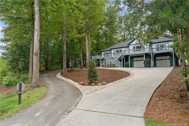 view of front facade featuring a wooden deck and a garage