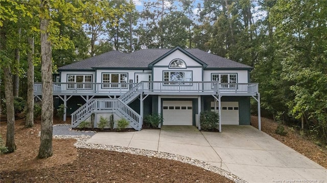 coastal inspired home with a garage and covered porch