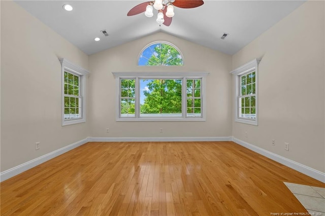 empty room with vaulted ceiling, ceiling fan, and light wood-type flooring