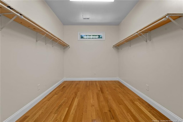 spacious closet featuring light hardwood / wood-style floors