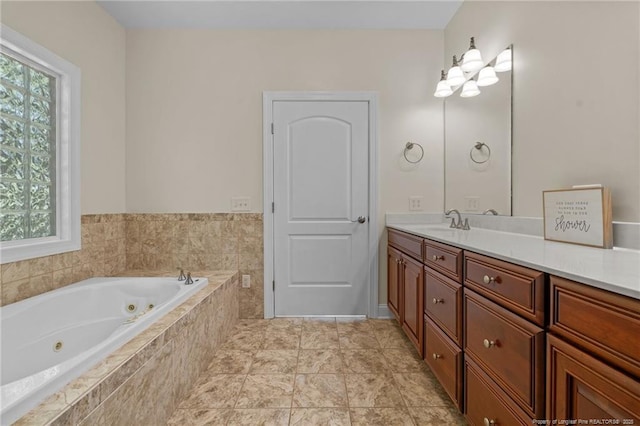 bathroom featuring a relaxing tiled tub, plenty of natural light, and vanity