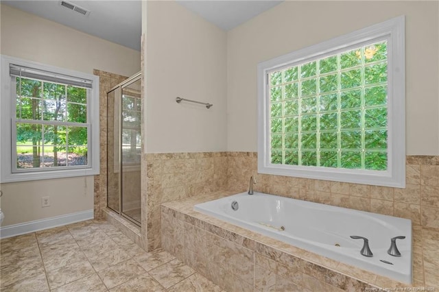 bathroom with tile patterned floors, plenty of natural light, and independent shower and bath