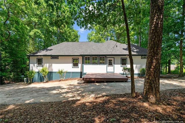 rear view of house featuring a deck