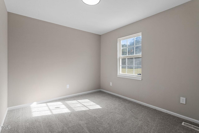 unfurnished room featuring light carpet