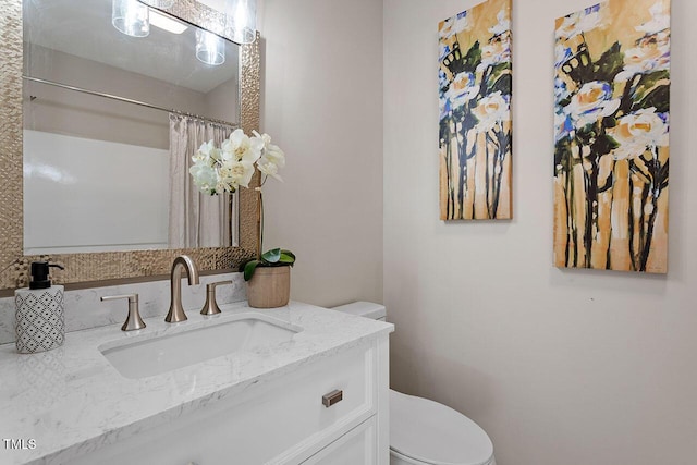 bathroom with vanity and toilet