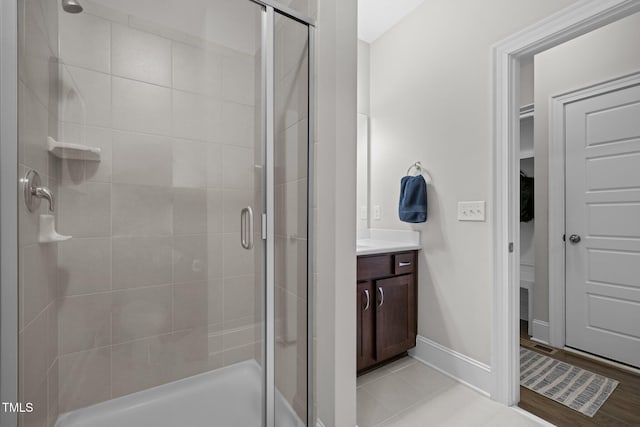 bathroom featuring vanity and a shower with shower door