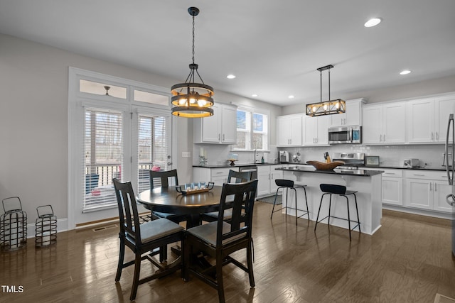 dining area with dark wood-type flooring and sink