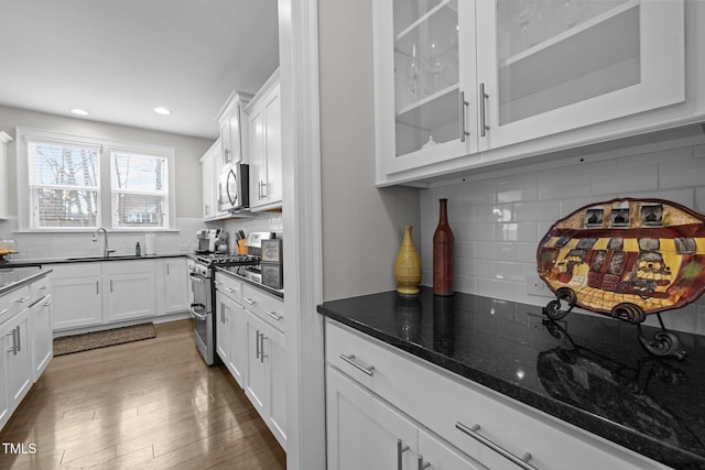 kitchen featuring white cabinetry, sink, dark hardwood / wood-style flooring, and stainless steel appliances