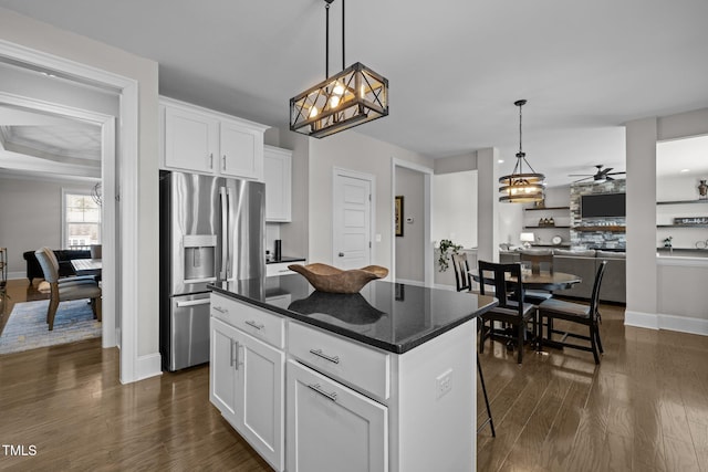 kitchen featuring white cabinetry, a breakfast bar area, dark hardwood / wood-style flooring, a center island, and stainless steel fridge with ice dispenser