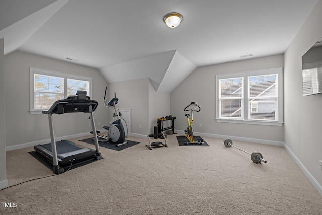 exercise area featuring lofted ceiling and light colored carpet