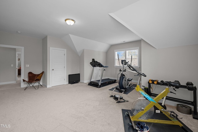 workout room featuring carpet floors and vaulted ceiling