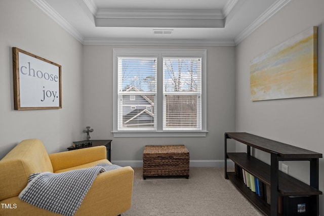 living area featuring ornamental molding, a tray ceiling, and carpet floors