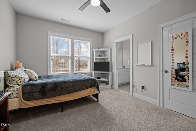 bedroom with ceiling fan, connected bathroom, and carpet