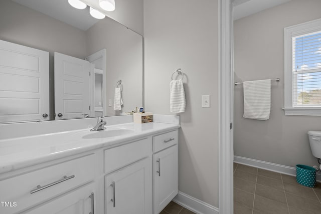 bathroom featuring tile patterned flooring, vanity, and toilet