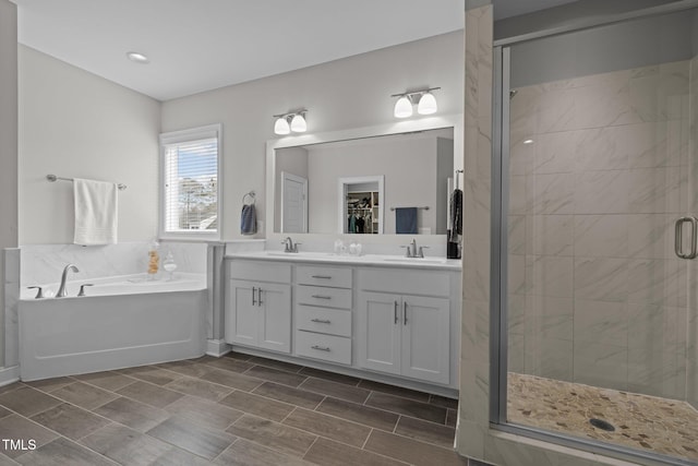 bathroom featuring vanity and separate shower and tub