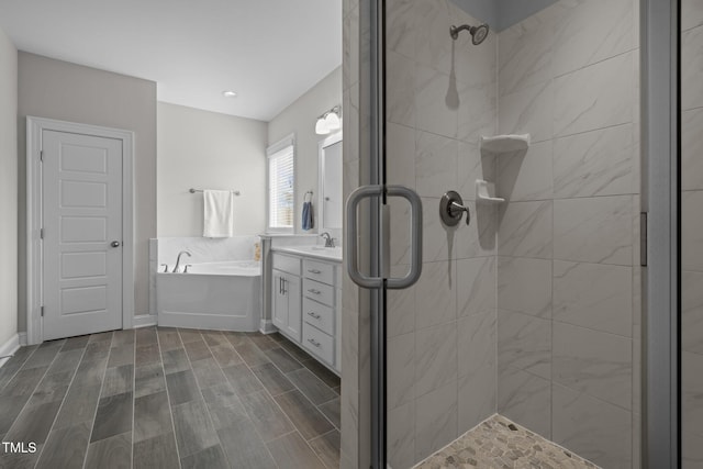 bathroom featuring vanity and shower with separate bathtub