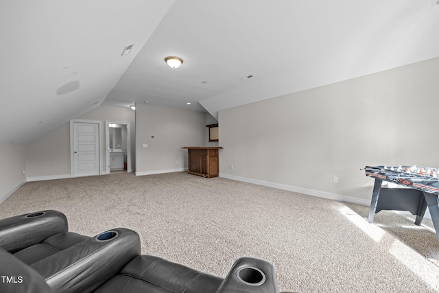 interior space featuring vaulted ceiling and carpet flooring