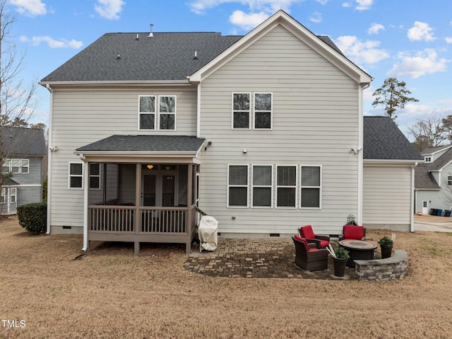 back of house with an outdoor fire pit, a yard, a patio, and a sunroom