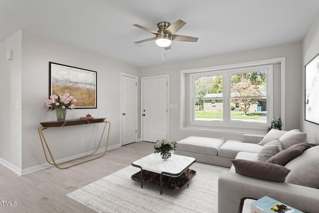 living room with ceiling fan and light hardwood / wood-style flooring