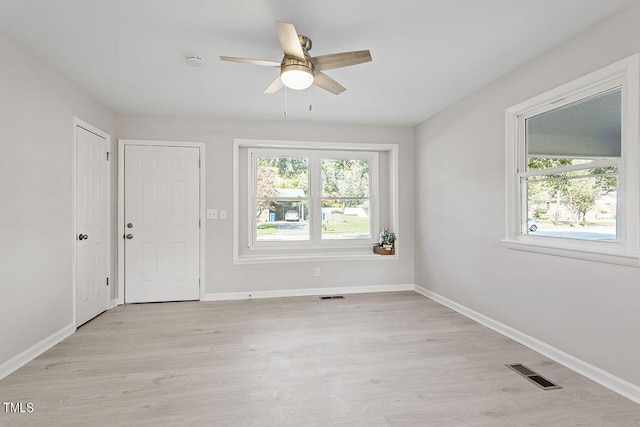 empty room with light hardwood / wood-style flooring and ceiling fan