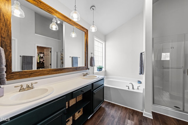8005 Chatahoochie Ln, Raleigh, NC 27616 - full bath featuring a stall shower, a spacious closet, double vanity, a garden tub, and wood finished floors