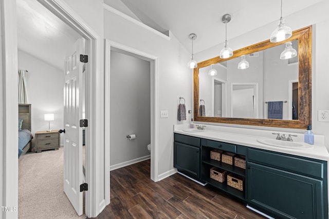 8005 Chatahoochie Ln, Raleigh, NC 27616 - bathroom featuring lofted ceiling, double vanity, ensuite bathroom, and wood finished floors