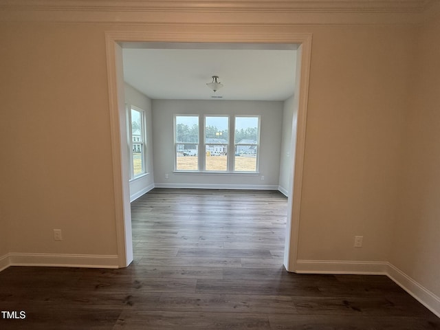 unfurnished dining area featuring ornamental molding and dark hardwood / wood-style floors