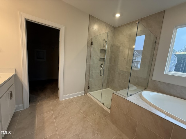 bathroom featuring vanity, tile patterned flooring, and plus walk in shower