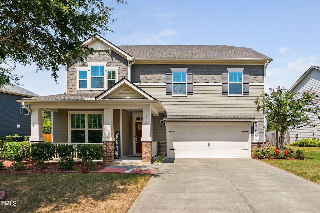 craftsman-style house featuring a garage and a porch