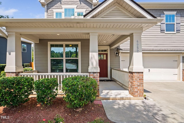 entrance to property featuring a garage and covered porch