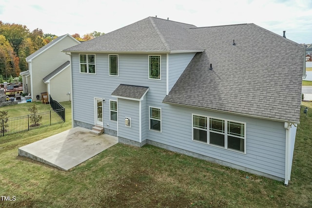 rear view of house featuring a patio area and a lawn