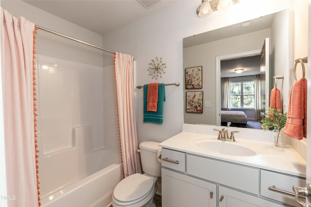 full bathroom featuring shower / bath combination with curtain, vanity, and toilet