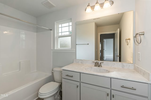 full bathroom featuring vanity, bathing tub / shower combination, and toilet