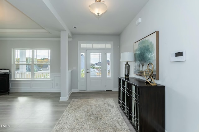 foyer entrance featuring hardwood / wood-style floors and ornamental molding