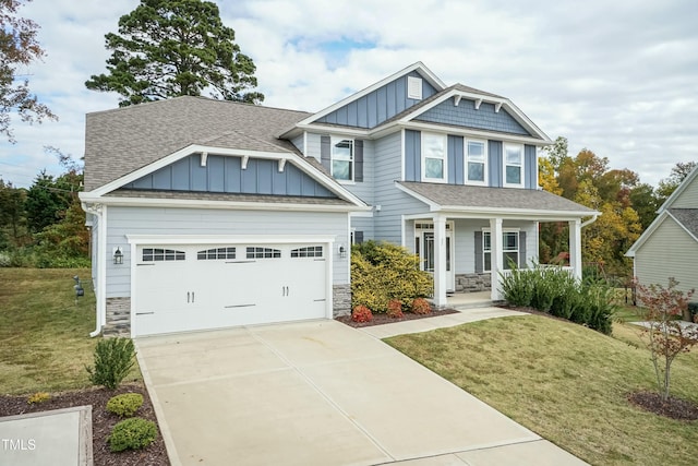 craftsman-style house with a garage, a front yard, and covered porch