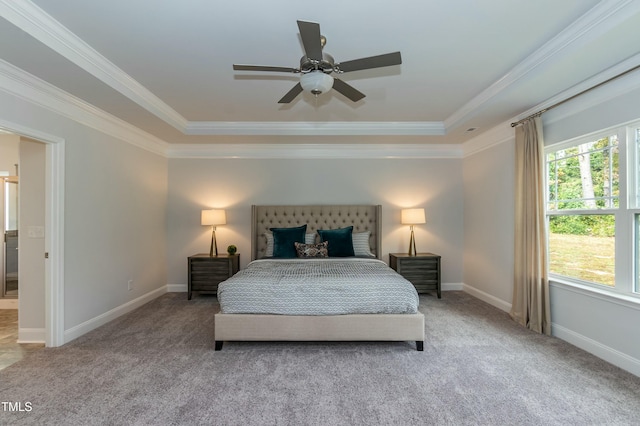 bedroom featuring crown molding, carpet, ceiling fan, and a tray ceiling