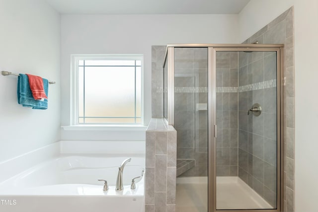 bathroom featuring shower with separate bathtub