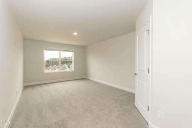 unfurnished room with light colored carpet