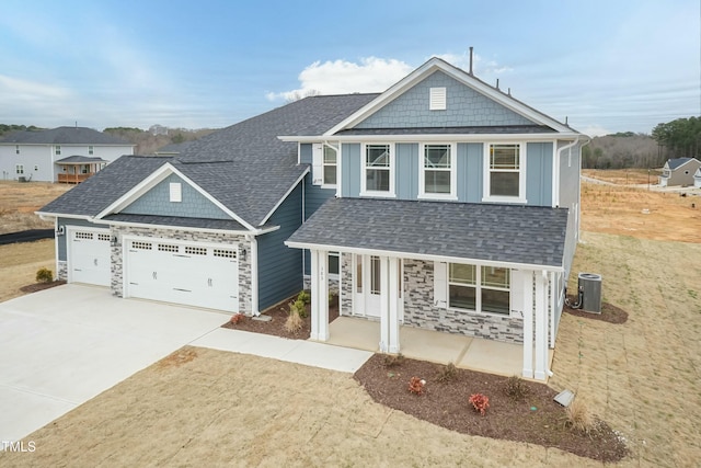 view of front facade featuring a garage, central AC unit, covered porch, and a front lawn