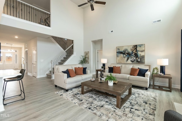 living room featuring ceiling fan and light hardwood / wood-style floors