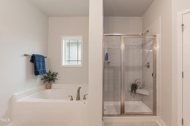 bathroom with separate shower and tub