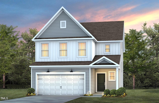 view of front of property featuring a garage and a lawn