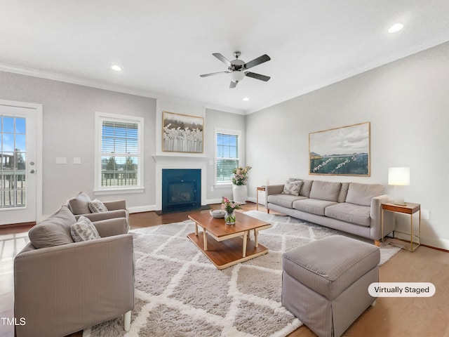 living room featuring crown molding and ceiling fan