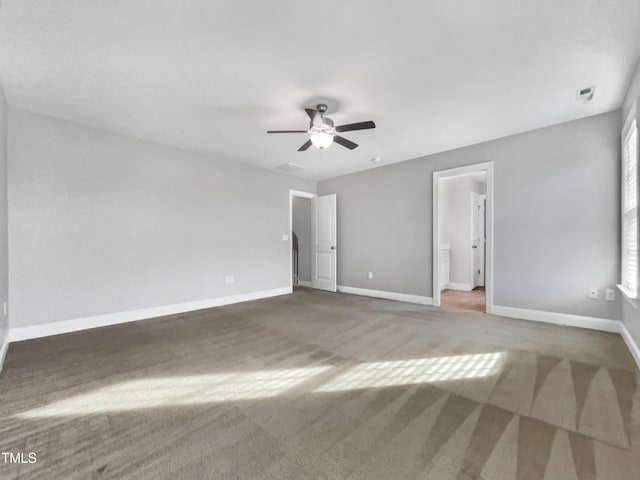 carpeted spare room featuring ceiling fan