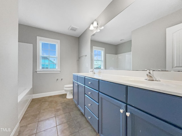 bathroom featuring tile patterned flooring, vanity, and toilet