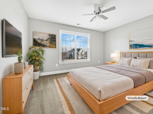 bedroom featuring hardwood / wood-style floors and ceiling fan